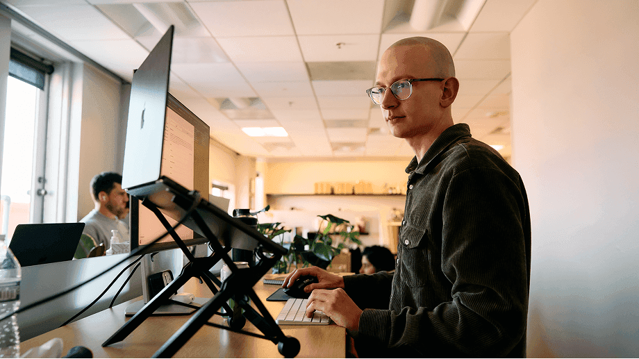 An engineer working at a standing desk in the Solidroad office